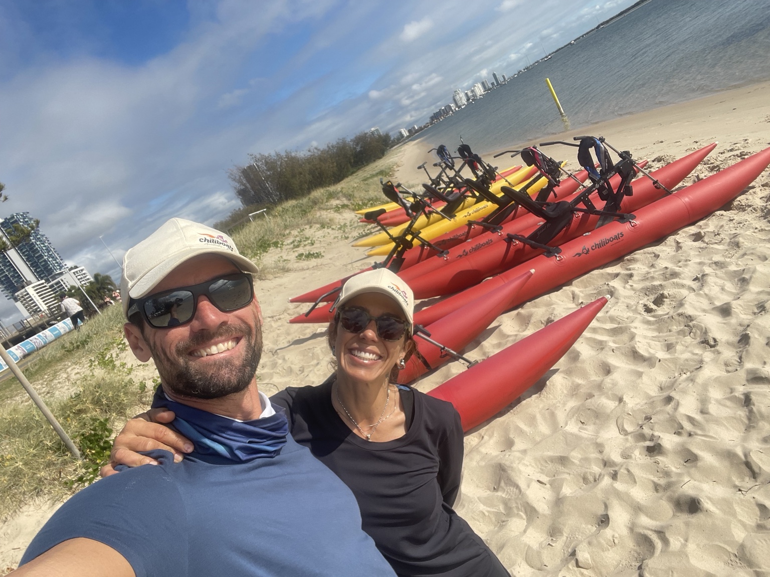Cédric and Andreia on the beach beside their waterbikes